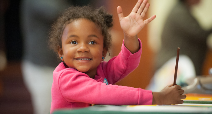 an image of two young girls working together in a library